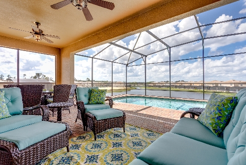 3213.pool deck with covered lanai comfy seating overlooking pond.JPG
